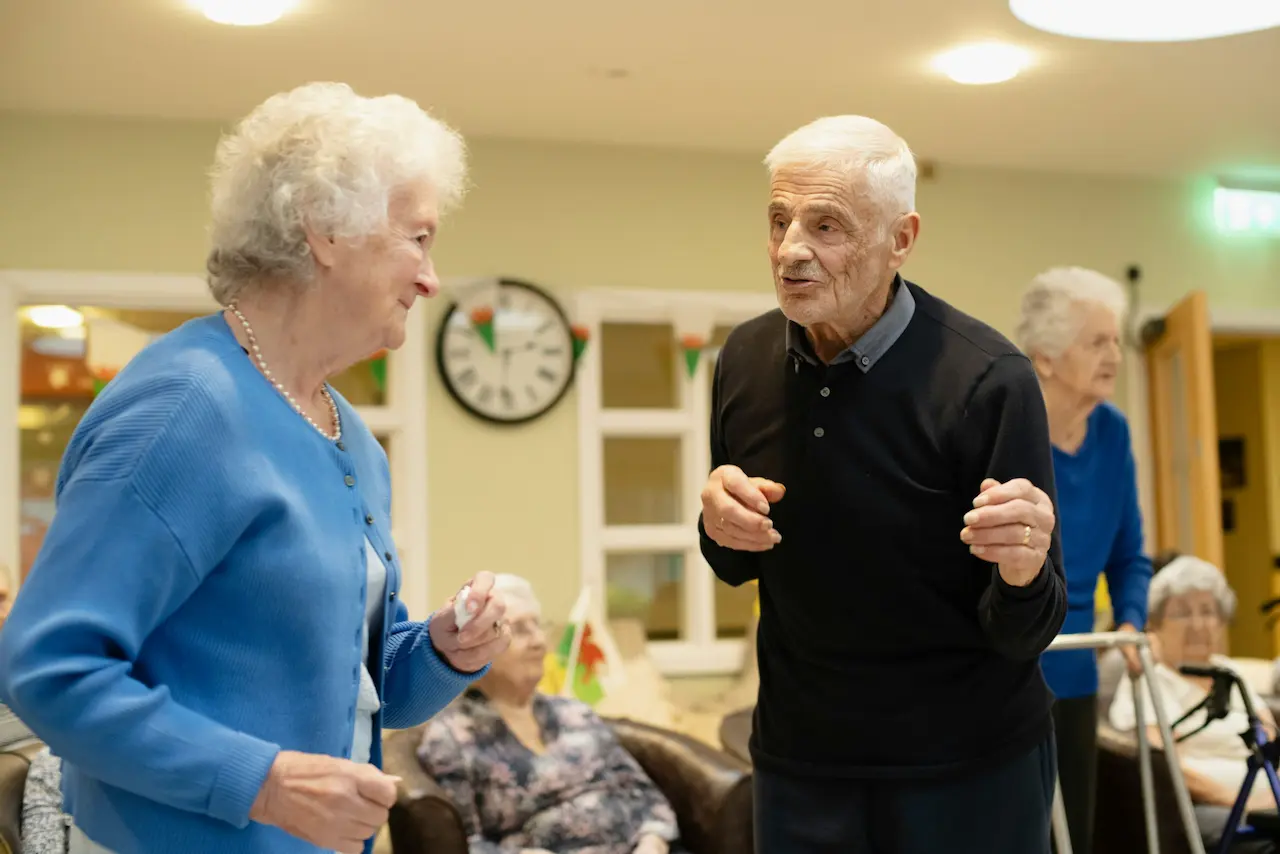 Active couple dancing in care home
